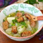 Bowl of lettuce & Pea Soup with new potatoes and croutons.