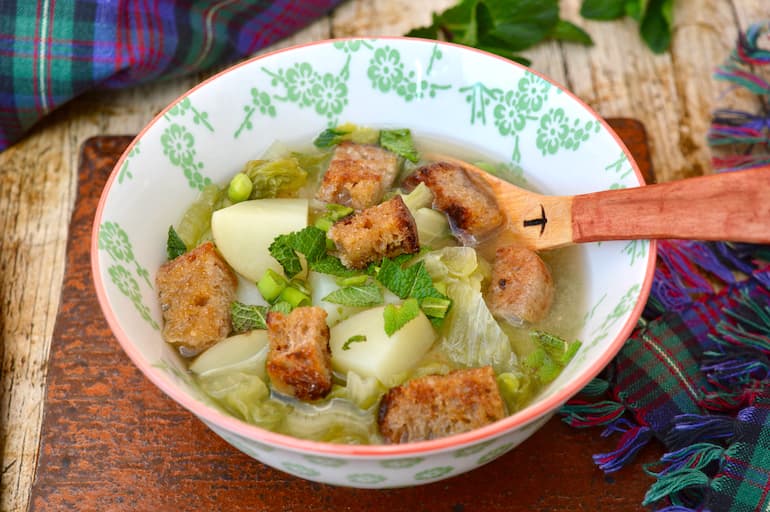 Bowl of lettuce & Pea Soup with new potatoes and croutons.