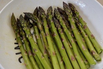 Raw asparagus spears drizzled with olive oil.