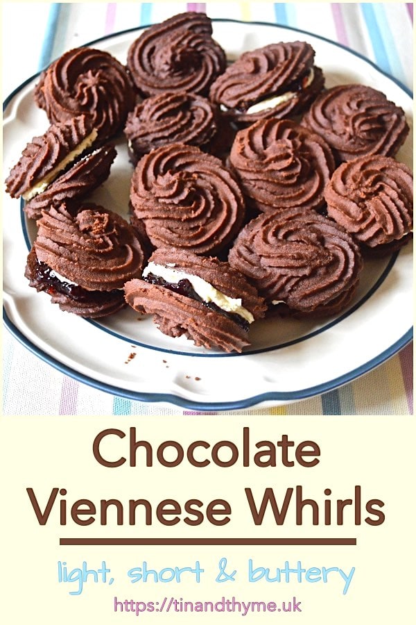 Plate of chocolate Viennese whirls sandwiched with blackcurrant jam and vanilla buttercream.