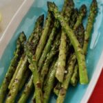 Close up of a dish of griddled asparagus.