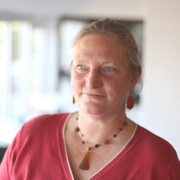 Portrait image of Choclette wearing red top.