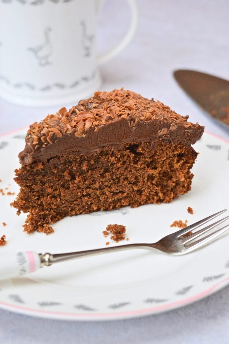 Slice of chocolate spice cake topped with whipped chocolate mousse.