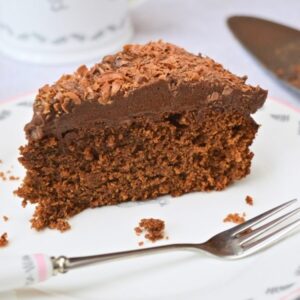 Slice of chocolate spice cake topped with whipped chocolate mousse.