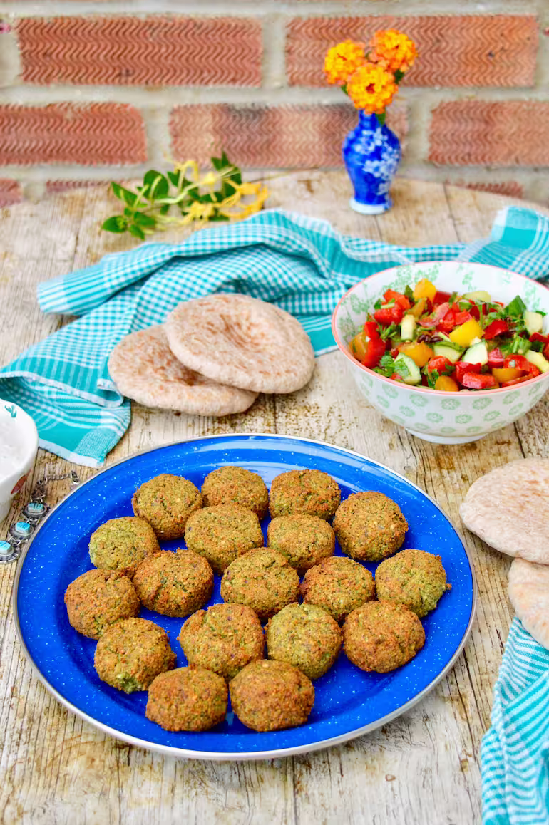 Air-fryer homemade falafel with chopped salad.