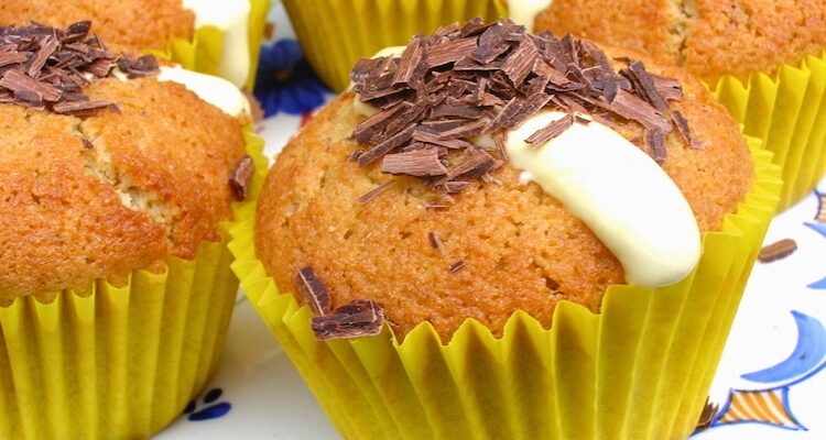Lemon Coconut Cakes in yellow cases with a sprinkling of chocolate over the top.