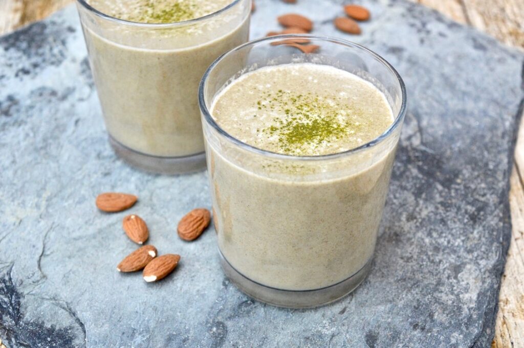 Glasses of almond matcha smoothies.