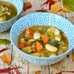 Two bowls of simple homemade chunky vegetable soup.