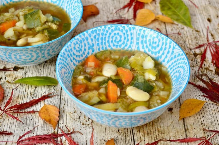 Two bowls of simple homemade chunky vegetable soup.