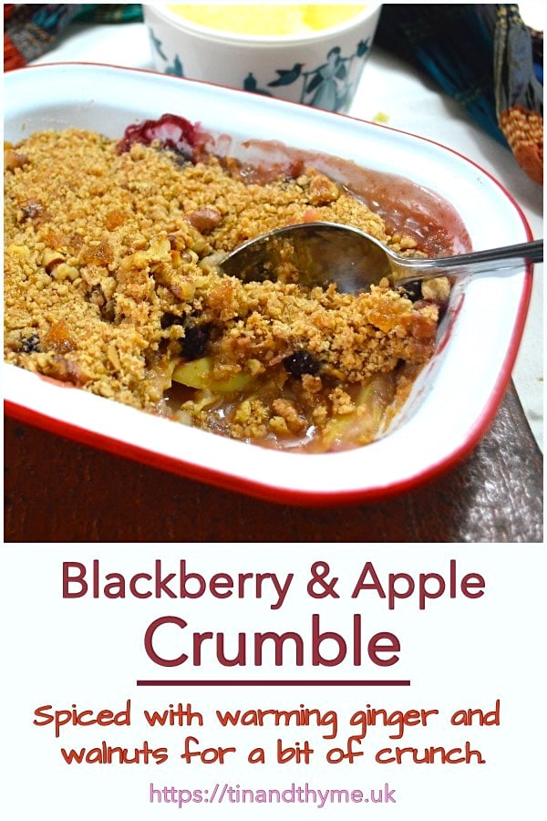 Blackberry and Apple Crumble with a bowl of clotted cream on the side.
