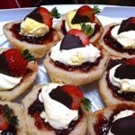 Cornish splits topped with strawberry jam, clotted cream and chocolate dipped strawberries.