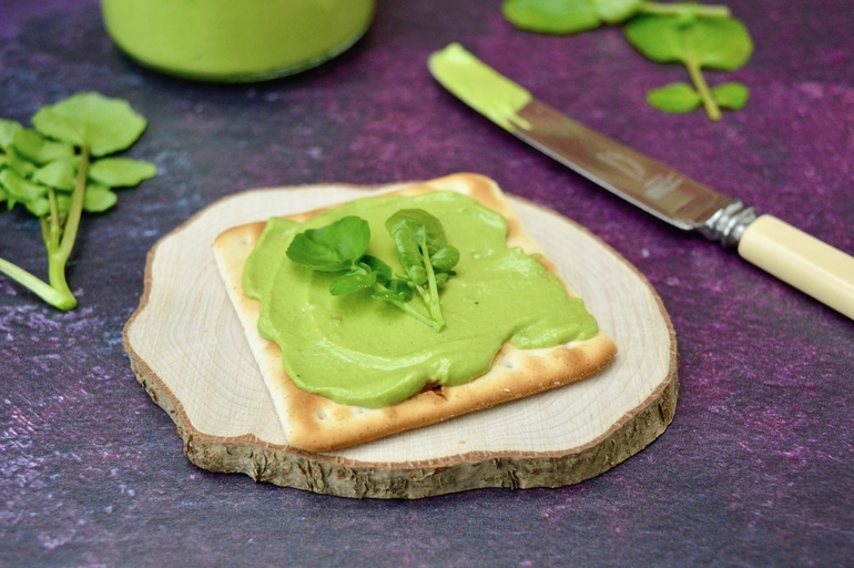 Watercress pesto in a jar and spread on a cracker.
