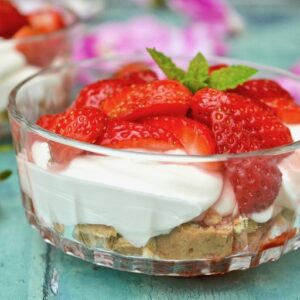 A bowl of strawberries and cream summer dessert.