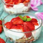 Two bowls of easy strawberries and cream dessert.