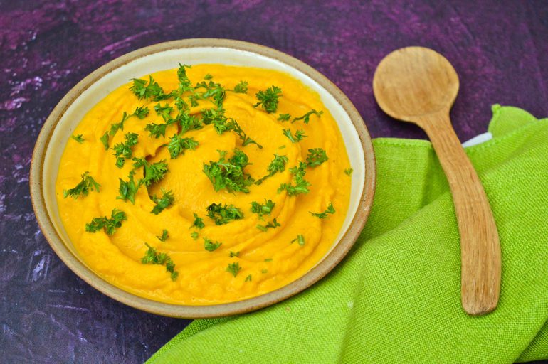 Moroccan carrot dip in a bowl and topped with parsley.