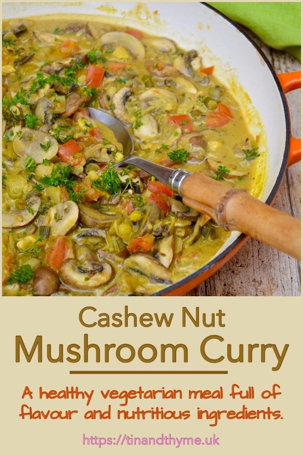 Mushroom curry in a casserole pan with a serving spoon.