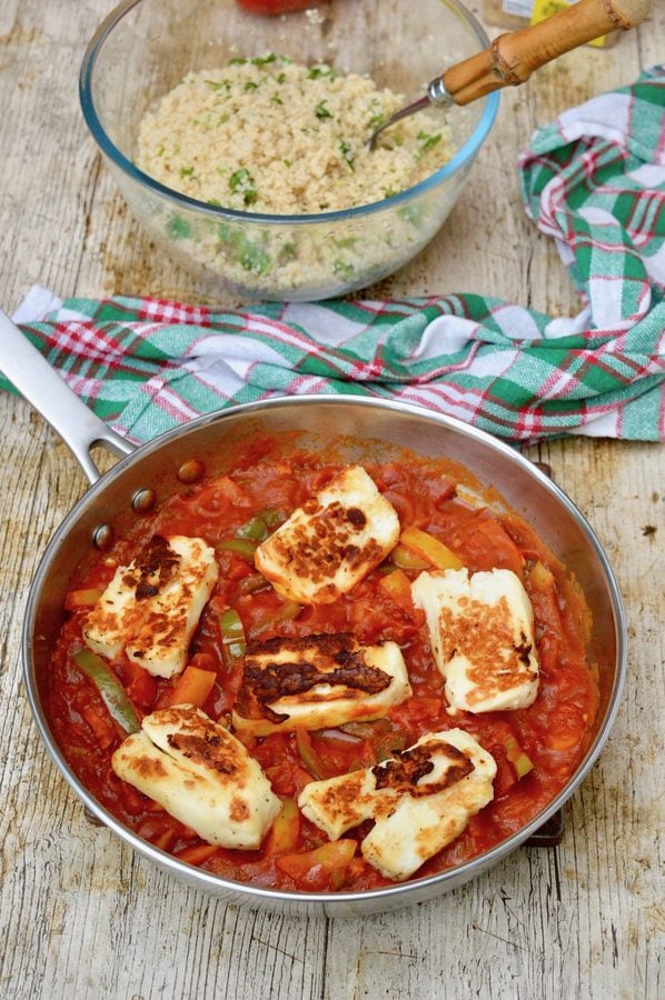 A pan of halloumi shakshuka and a bowl of herby couscous.