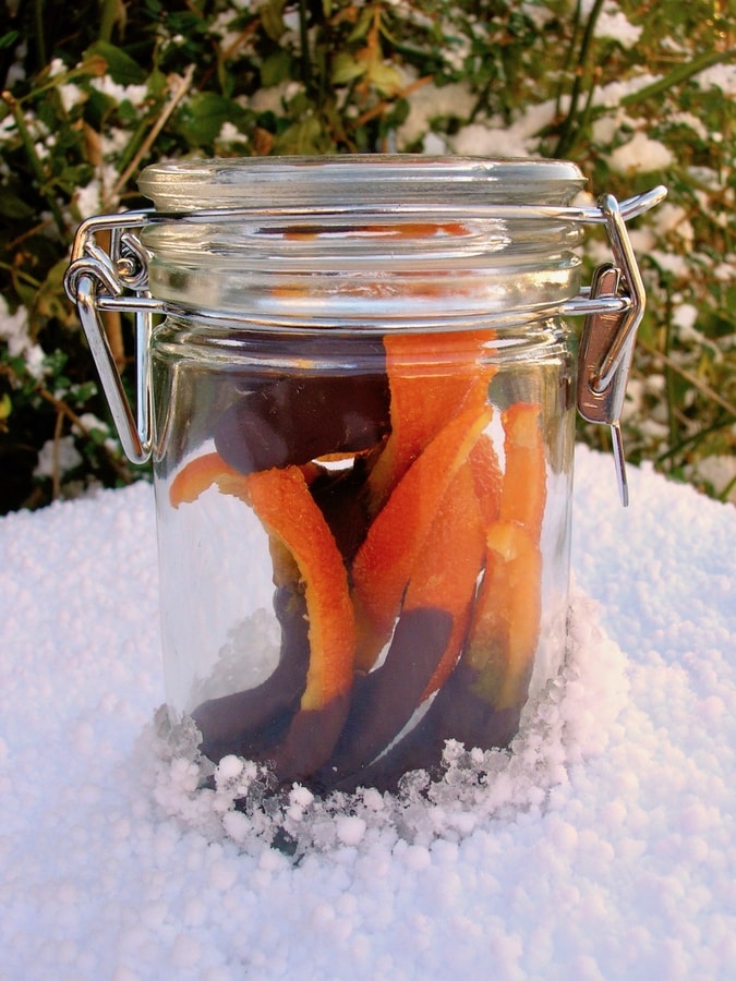 A jar of candied orange peel dipped in dark chocolate.