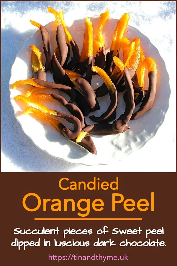 A plate of candied orange peel dipped in dark chocolate.