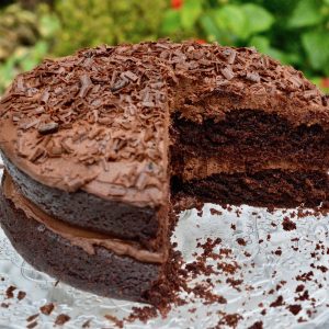 Celebratory Vegan Chocolate Cake with chocolate tofu icing and chocolate shavings.