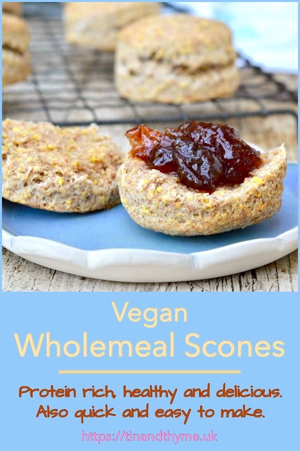 Vegan wholemeal scones with one split and spread with jam.