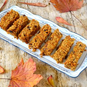 Platter of carrot cake flapjacks with autumn leaves.