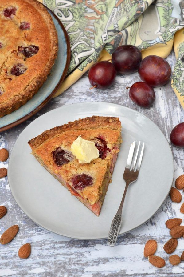 A slice of Plum Almond Tart with clotted cream.
