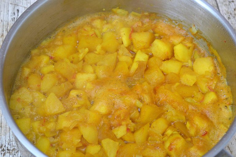 Apple chutney cooking in a pan.
