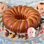Spiced orange pumpkin cake with Halloween decorations.