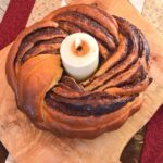 Chocolate Babka Bundt with a lighted candle in the middle.