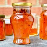 Jars of quince jelly with apples and chilli flakes.