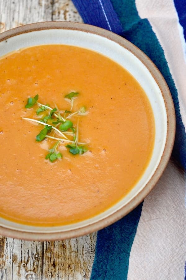 A bowl of roasted tomato soup with lentils and carrots.