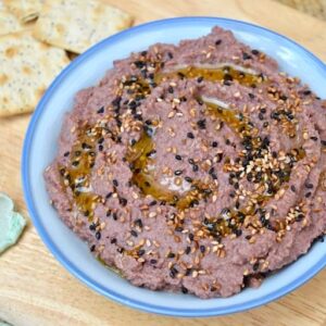 Aduki Bean Miso Dip scattered with black & white toasted sesame seeds and drizzled with oil.