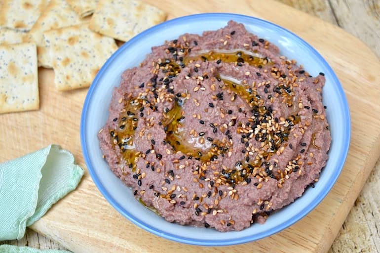 Aduki Bean Miso Dip scattered with black & white toasted sesame seeds and drizzled with oil.