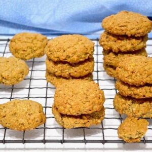 Crunchy Peanut Butter Cookies piled on a cooling rack.