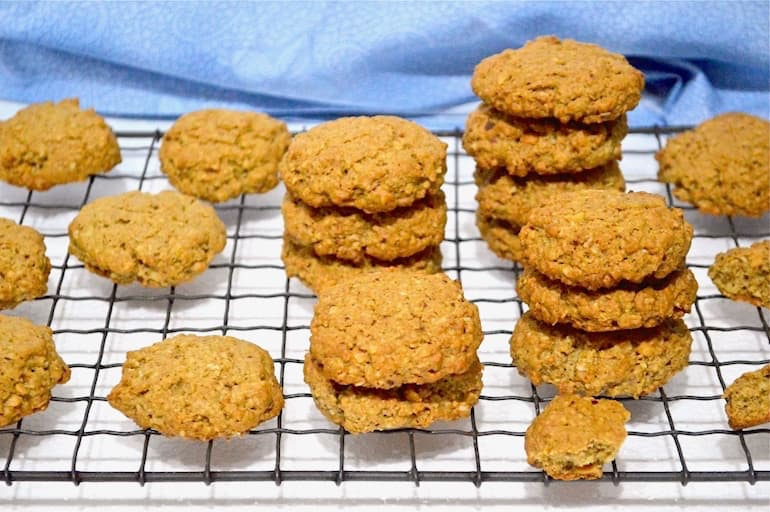 Crunchy Peanut Butter Cookies piled on a cooling rack.
