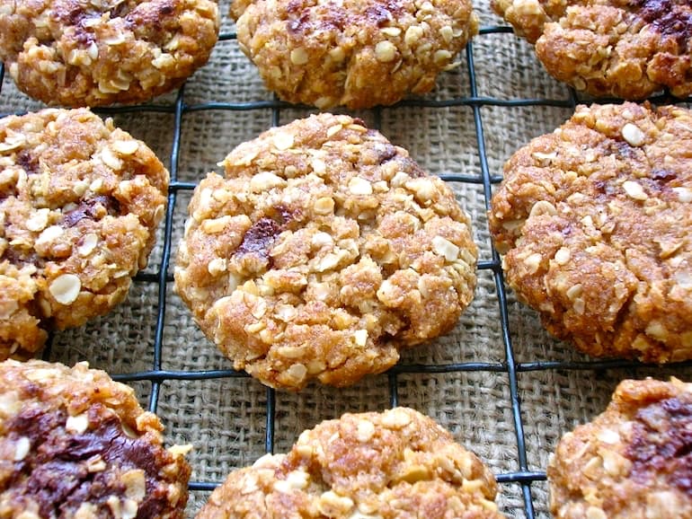 Oaty Ginger Chocolate Chip Cookies cooling on a wire rack.