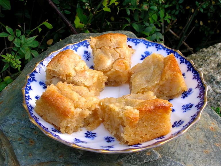 A plate of banana blondies with caramelised brazil nuts.