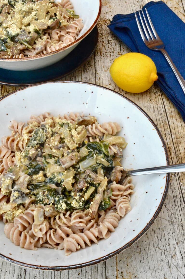 Fresh-tasting vegetarian pasta dish with mushrooms and Swiss chard in a garlic and lemon creamy sauce.