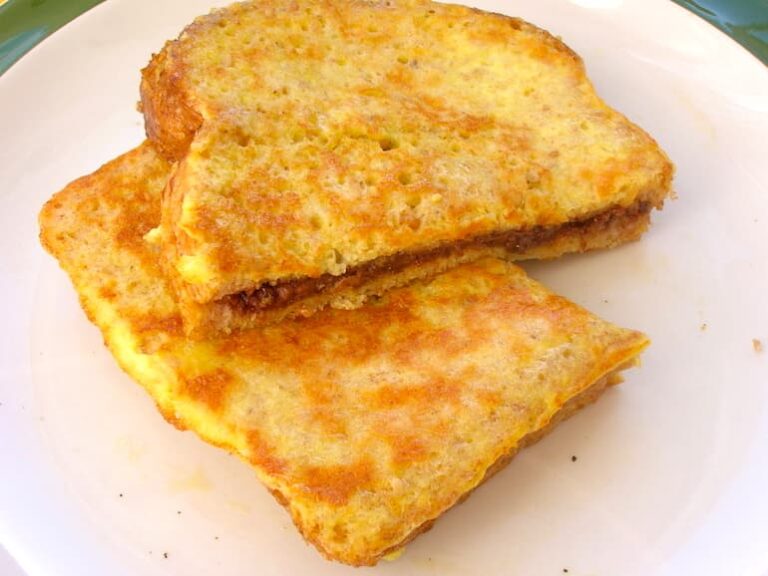 Two pieces of a Nutella French toast sandwich.