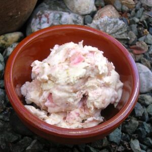 Bowl of rhubarb and rose white chocolate ripple ice cream.