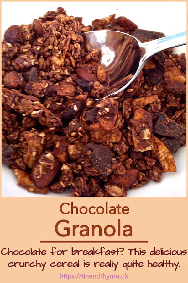 A bowl of homemade chocolate granola with spoon. Pin text reads "Chocolate for breakfast? This delicious crunchy cereal is really quite healthy."