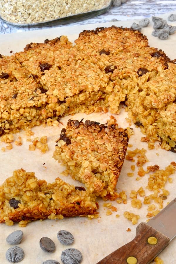 Crumbly chocolate orange flapjacks on a board.