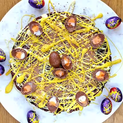 Gluten-free Easter tiffin covered in mini creme eggs.
