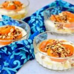 Four glass bowls of deconstructed Apricot Whisky and Honey Cheesecake.