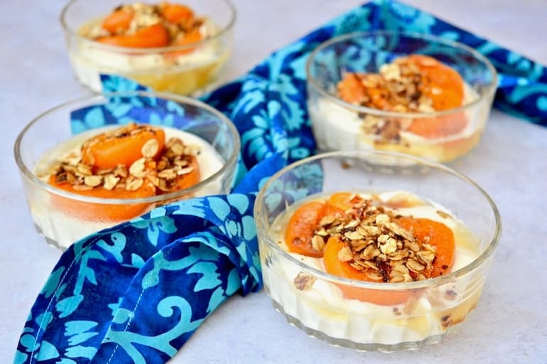 Four glass bowls of deconstructed Apricot Whisky and Honey Cheesecake.