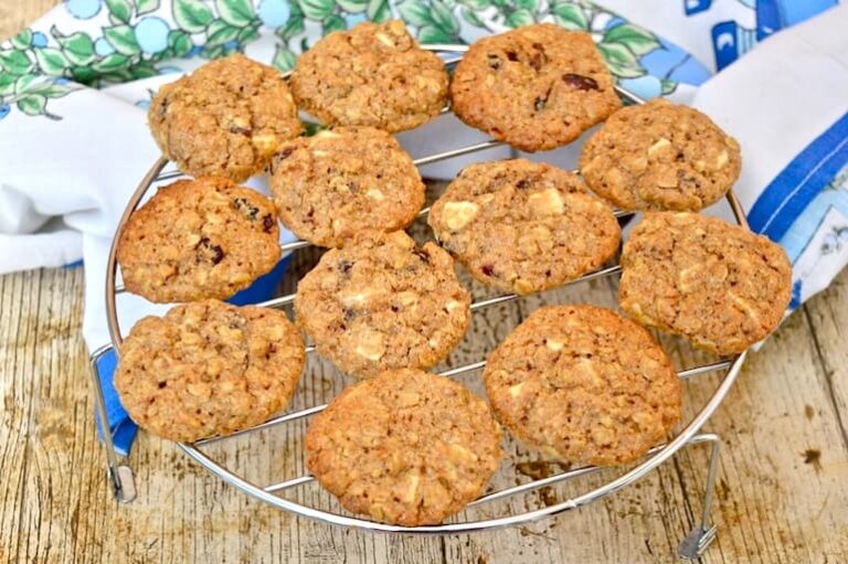Walnut & cranberry white chocolate cookies on a cooling rack.