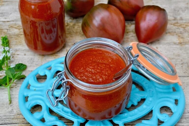 An open jar of easy homemade tomato sauce.