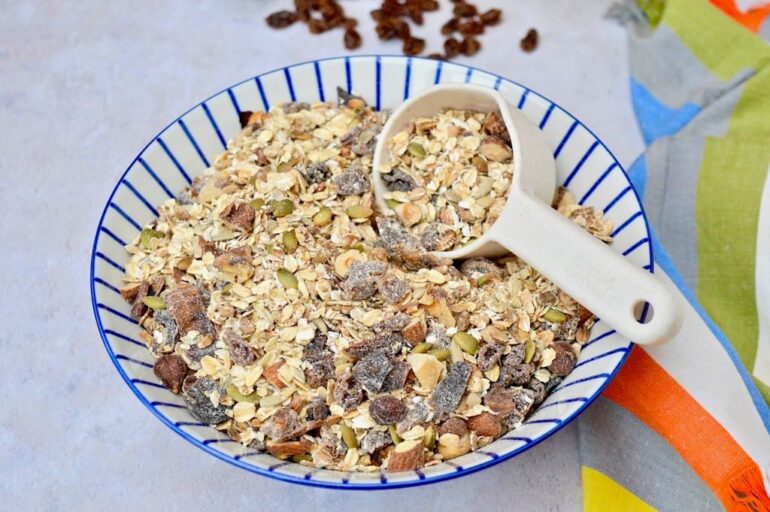 A bowl of healthy homemade toasted muesli with scoop.