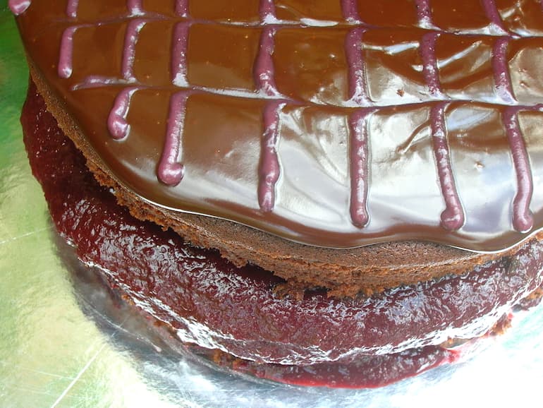 Chocolate blackberry cake with jam filling, chocolate ganache and blackberry feathering on the top.